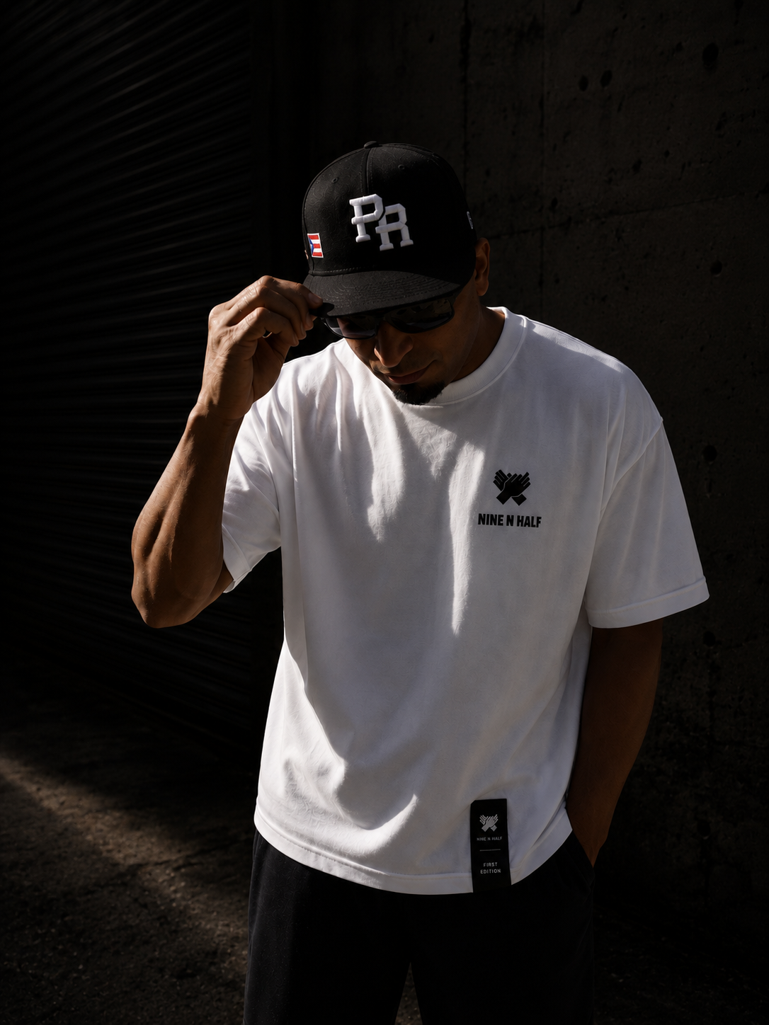     Front view of the Nine N Half First Edition Tee In white color and hem patch