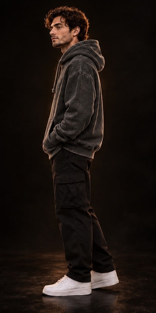     Model wearing vintage black oversized hoodie, side-profile fit