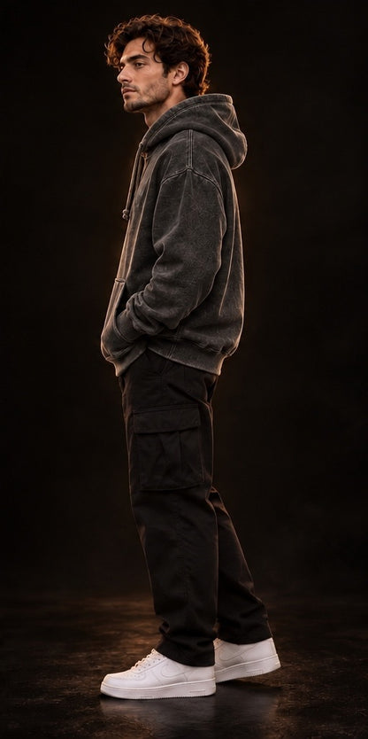     Model wearing vintage black oversized hoodie, side-profile fit
