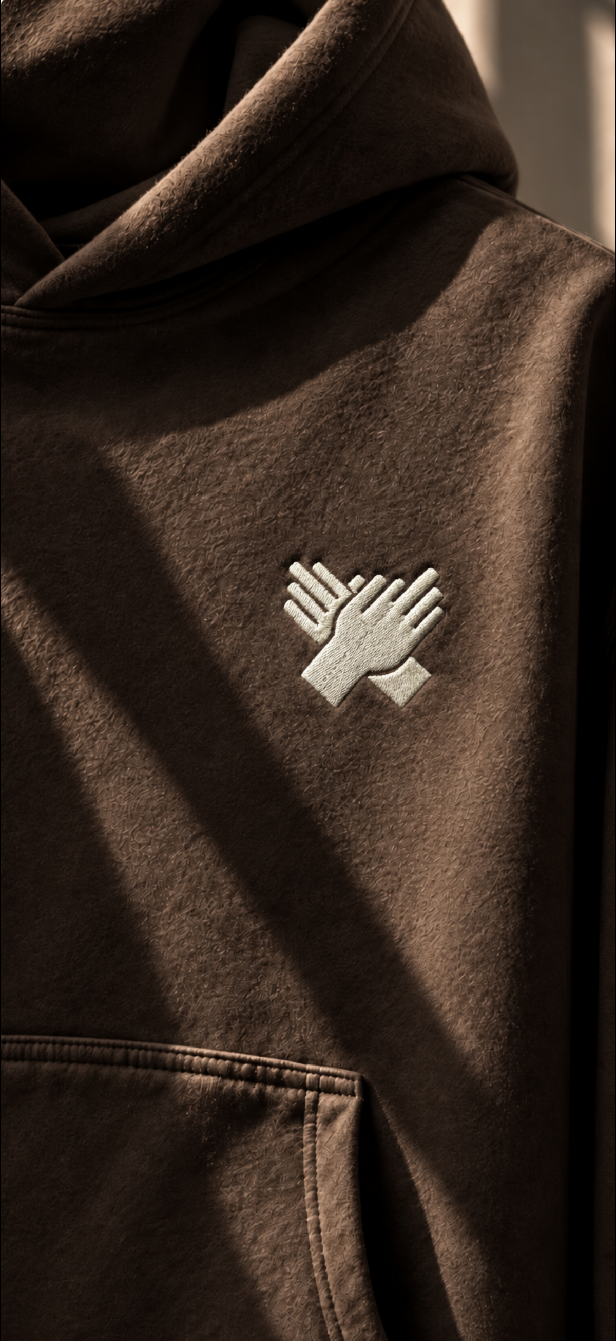     NINE N HALF embroidered hand logo on brown heavyweight hoodie – close-up
